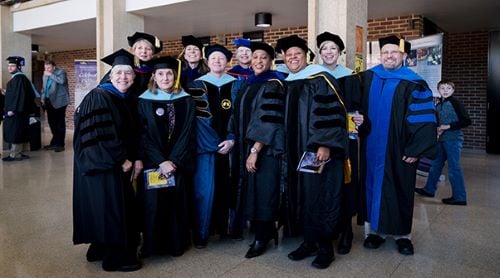 College of Education faculty posing at graduation