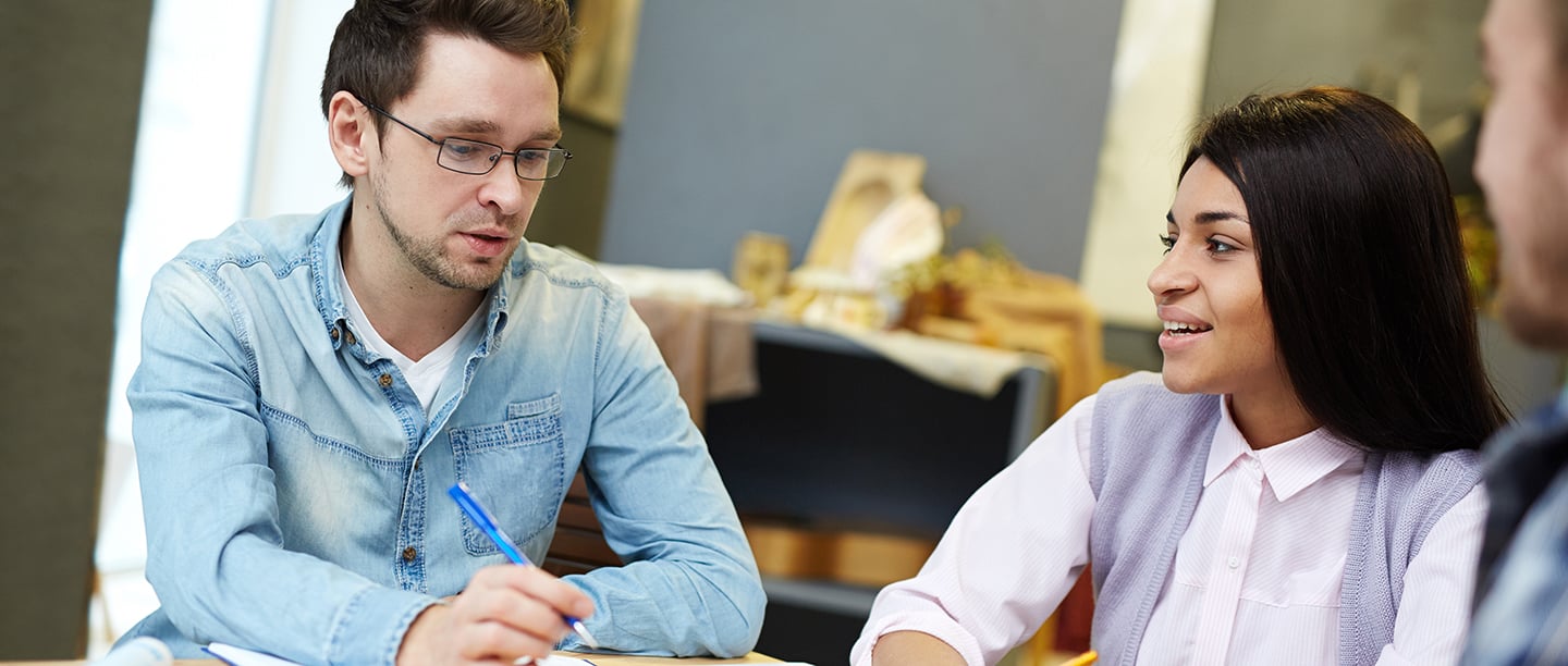 Three person communicating with each other and writing down notes with each other