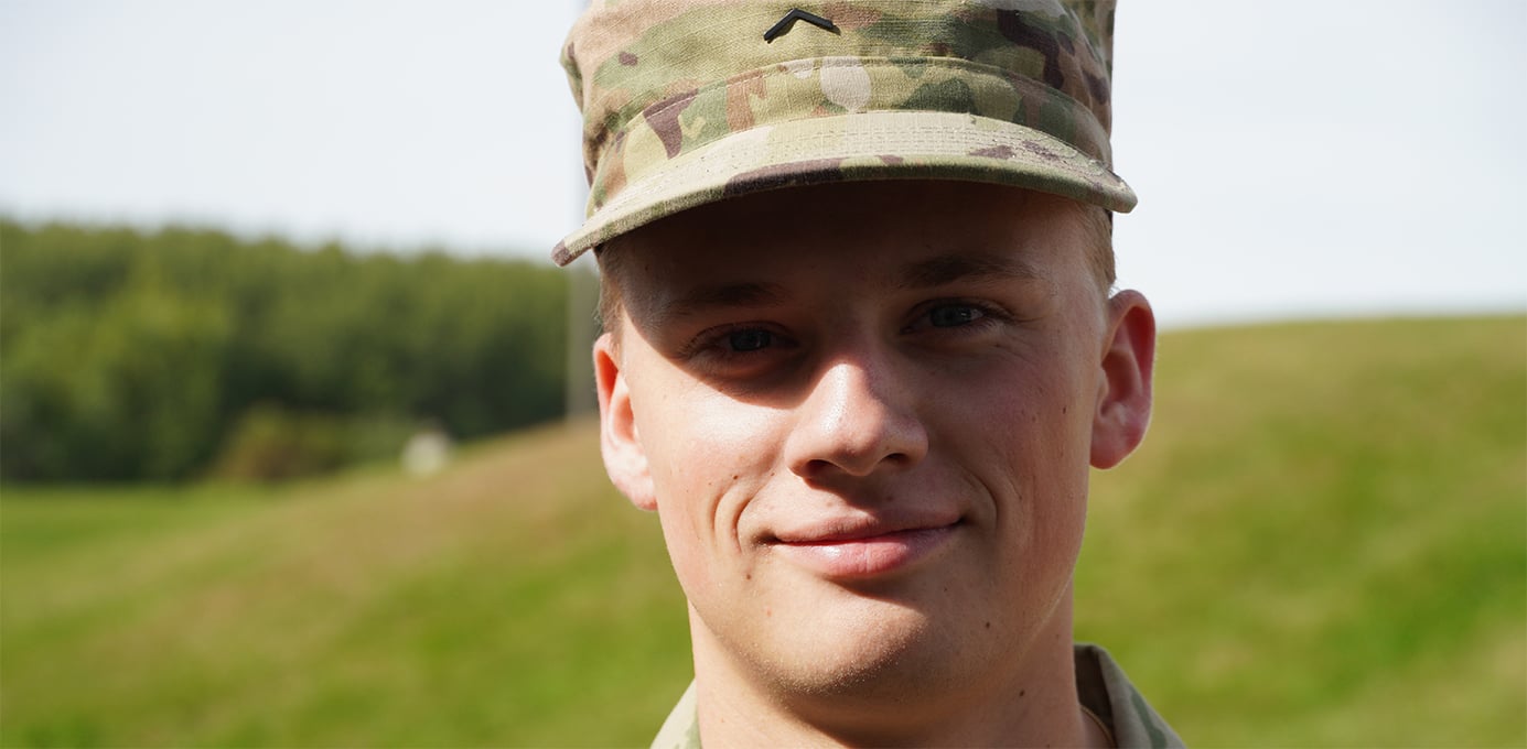 a person in a camouflage hat